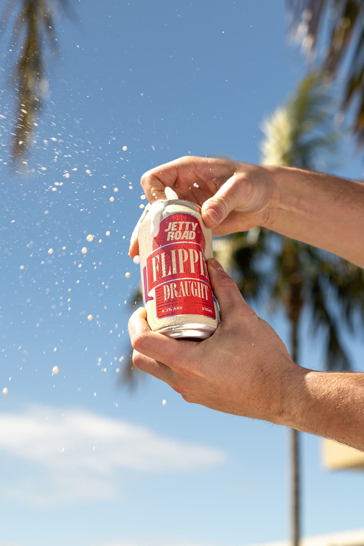 Jetty Road Flippin' Draught cracking open under a palm tree
